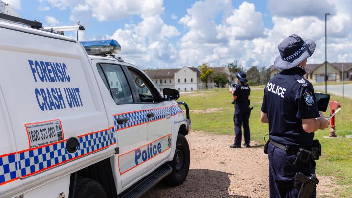 Forensic Crash unit officers and police vehicle