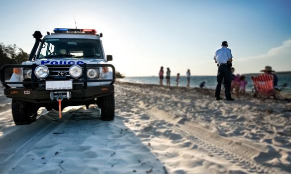 Police vehicle on the beach with an officer