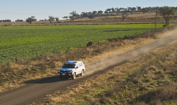 Police vehicle on country road