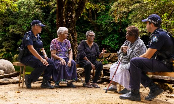 Police officers having a yarn with elders