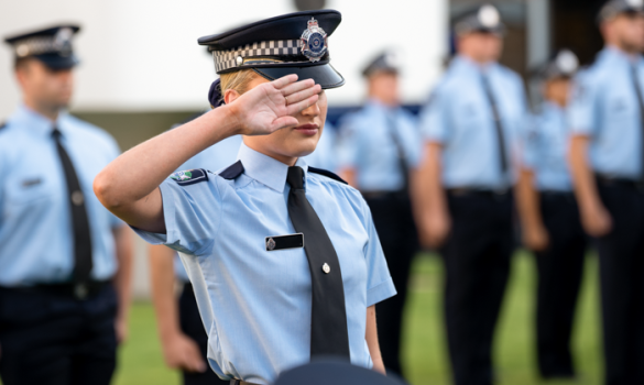police recruit salutes at graduation