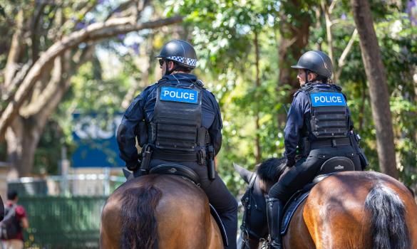 Two mounted unit officers patrol on horseback