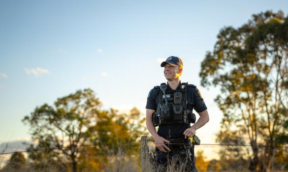 Police officer in field in regional Kingaroy