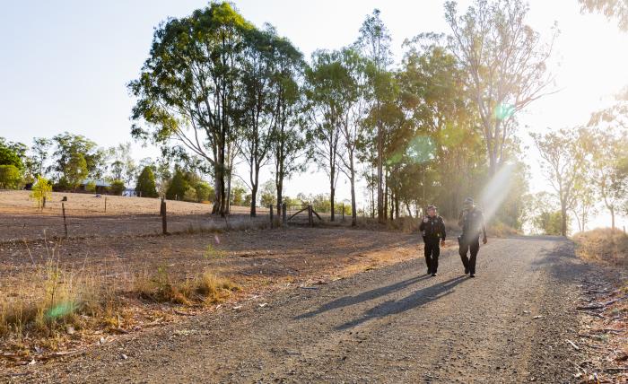 Police officers walking on country road