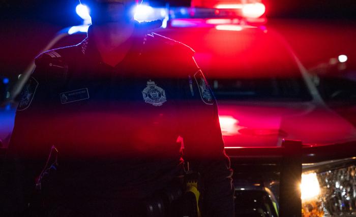 Queensland police officer and car with red blue lights