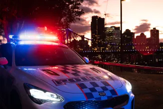 Police vehicle with city in background