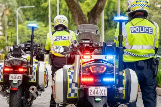 QPS highway patrol motorbikes and officers with lights flashing