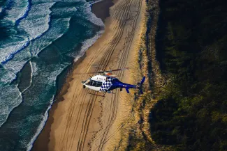 PolAir helicopter flying over coastline